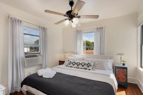 a bedroom with a bed with a ceiling fan at The Wildflower- Monthly Rental - Walk Everywhere in Fayetteville