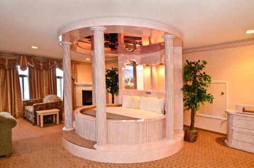 a large room with a large bed in a suite at Atlantis Family Waterpark Hotel, an Ascend Collection Hotel in Wisconsin Dells