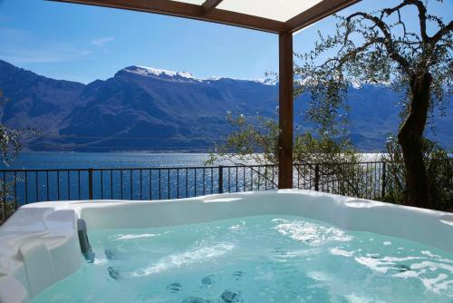 a bath tub with a view of a mountain at Hotel Atilius - Adults Only in Limone sul Garda