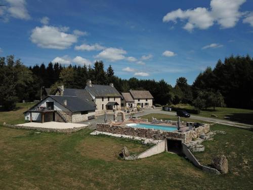 an aerial view of a house with a swimming pool at Domaine des Annouillards in Sornac