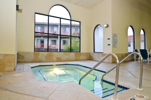a swimming pool in a building with windows at Atlantis Family Waterpark Hotel, an Ascend Collection Hotel in Wisconsin Dells