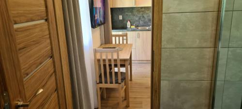 a small kitchen with a table and a dining room at Apartmán u Toma in Frýdlant nad Ostravicí