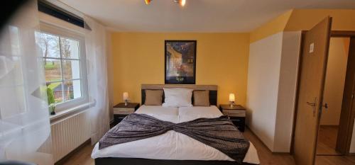 a bedroom with a bed with a bow on it at Haus Stadt Hannover am Park in Rollshausen