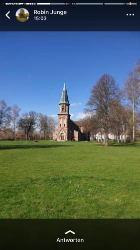 a picture of a building with a tower in a field at Haus Stadt Hannover am Park in Rollshausen