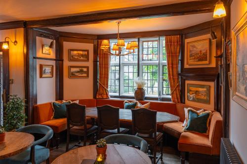 a restaurant with tables and chairs and a window at Stone House Hotel in Hawes