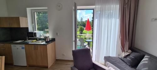 a living room with a couch and a window at Apartmán u Toma in Frýdlant nad Ostravicí