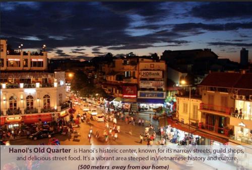 a busy city street at night with people and buildings at La Casa Di Dicembre 35A Nhà Chung in Hanoi