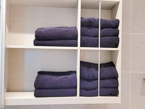 um monte de toalhas sentadas numa prateleira em Emotion-고층뷰, 3룸, 화2 신축, 건조기, 세탁기, 이마트2분, 별내역3분, 출장 및 장기숙박 추천 em Namyangju