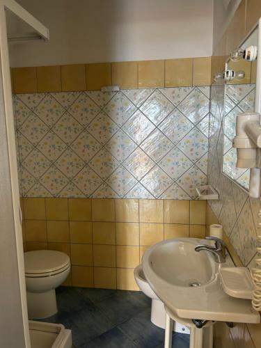 a bathroom with a sink and a toilet at Hotel le 3 lanterne in Marina di Sibari