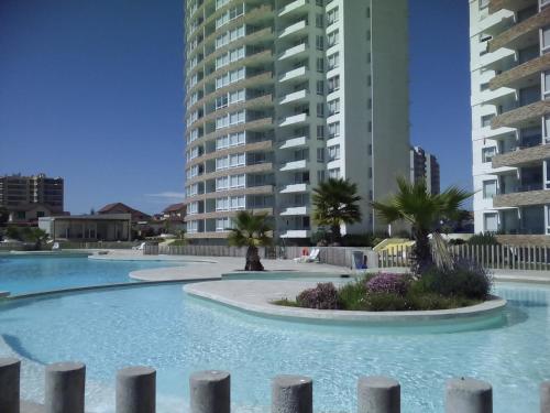 a swimming pool in front of two tall buildings at Playa Herradura in Coquimbo