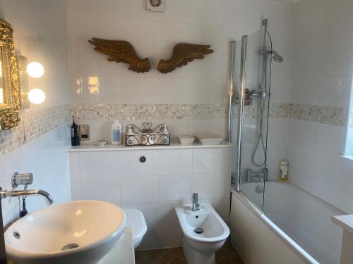 a bathroom with a sink and a toilet and a shower at Stunning 2 bed 2 bath house in Carleton in Pontefract