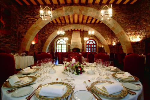 a table set up for a wedding in a stone room at HOTEL & SPA El Castell de Ciutat in La Seu d'Urgell