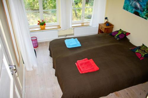 a bedroom with a large bed with two towels on it at B&B Eco-Village 12 min from city in Stockholm