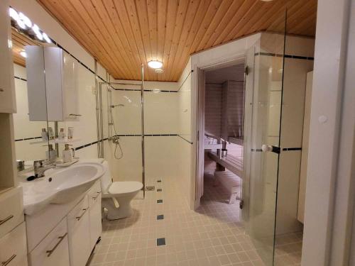 a bathroom with a toilet and a sink and a shower at Uniq Home Helsinki in Helsinki