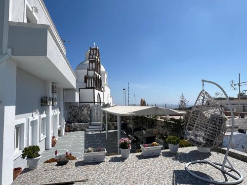 a courtyard of a building with a church at Villa Pavlina in Karterados