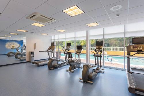 a gym with cardio equipment and a swimming pool at SpringHill Suites Tampa North/Tampa Palms in Tampa
