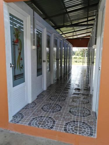 a hallway of a house with a tile floor and doors at FriendTogether Armthong in Ban Khlong Kathon