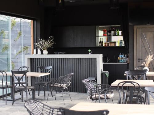 a restaurant with tables and chairs and a bar at Świerkowa Osada in Istebna