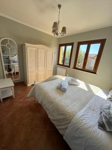 a bedroom with a large bed with towels on it at CS Holiday in Castelnuovo Berardenga