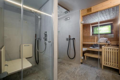 a bathroom with a shower and a glass shower stall at Kirchberg Chalet by Alpine Host Helpers in Kirchberg in Tirol