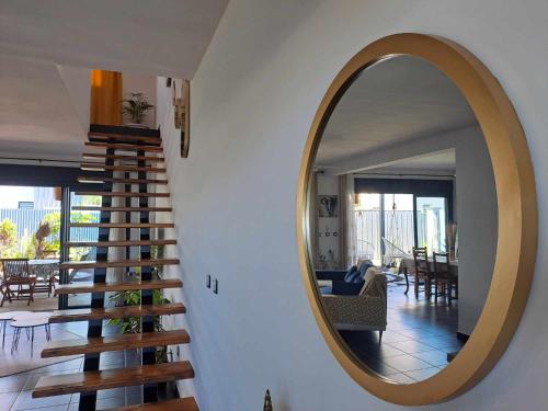 a staircase in a house with a mirror on the wall at La Villa Manaïck in Saint-André
