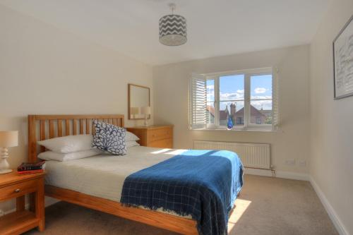 a bedroom with a bed and a window at 2 Studley Gardens in Lyme Regis