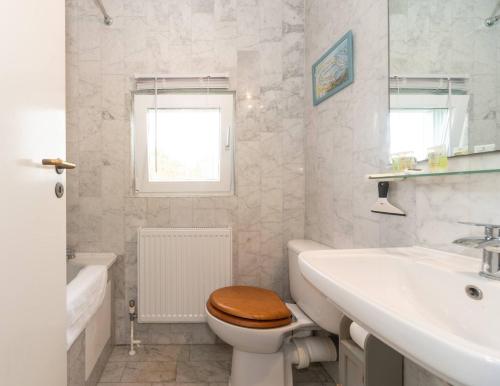 uma casa de banho branca com um WC e um lavatório em Pass the Keys - Sunny flat with Great views over Canary Wharf, London em Londres