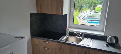 a kitchen counter with a sink and a window at Apartmán u Toma in Frýdlant nad Ostravicí