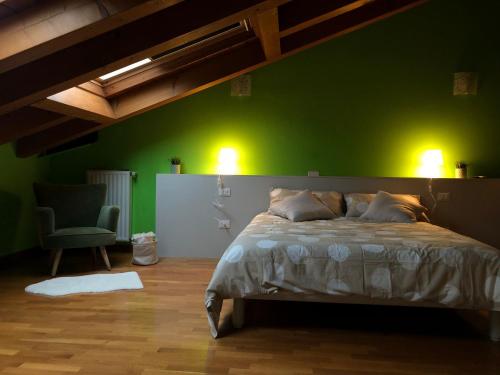 een groene slaapkamer met een bed en een groene muur bij ALLOGGIO IL TRULLO in Borso del Grappa