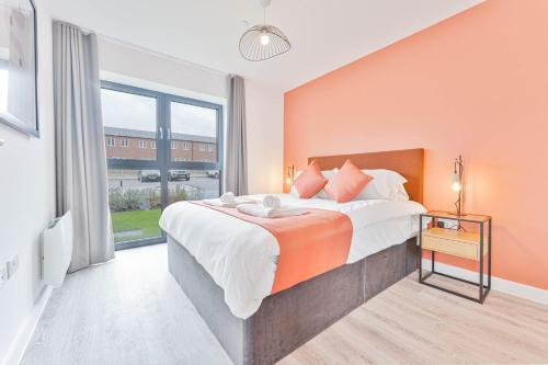 a bedroom with a large bed and a large window at Smart 1 Bed Apartment Nightingale Quarter Derby in Derby