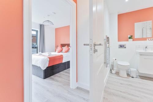 een badkamer met een slaapkamer met een bed en een toilet bij Smart 1 Bed Apartment Nightingale Quarter Derby in Derby