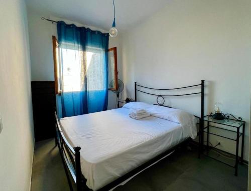 ein Schlafzimmer mit einem Bett mit einem blauen Vorhang in der Unterkunft Be Your Home - Casa Vetulonia in Santa Marinella