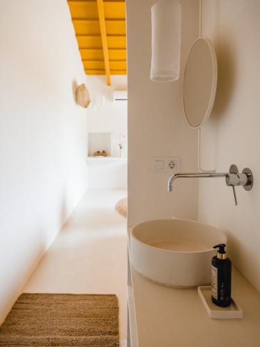a bathroom with a sink and a mirror on the wall at Amagatay Luxury Boutique Hotel - Adults Only in Alaior