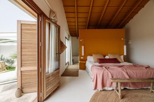 a bedroom with a large bed and a window at Amagatay Luxury Boutique Hotel - Adults Only in Alaior