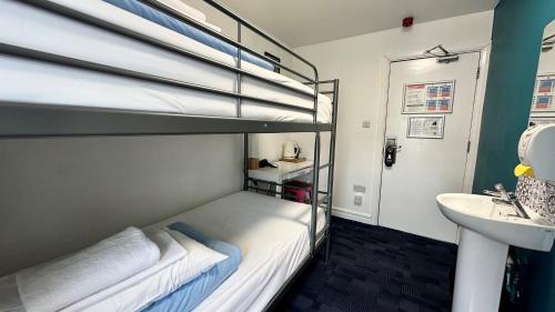 a bedroom with a bunk bed and a sink at Smart Hyde Park Inn in London