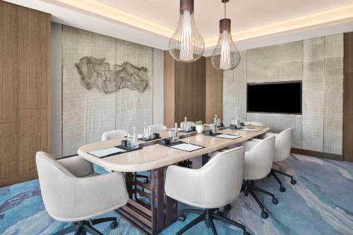 a dining room with a large table and chairs at JW Marriott Hotel Taiyuan in Taiyuan
