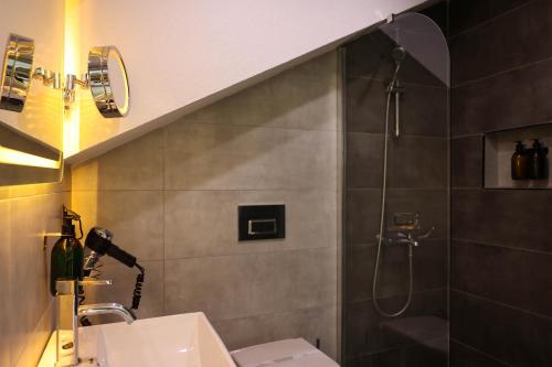 a bathroom with a sink and a shower at Gardenmode Airport Hotel in Taşoluk