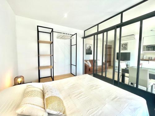 - une chambre avec un grand lit blanc et des fenêtres dans l'établissement Copacabana beach, by Welcome to Cannes, à Cannes