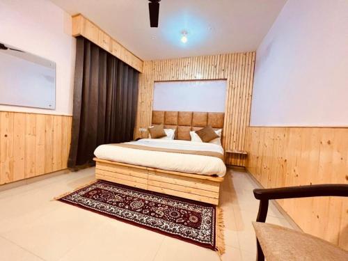 a bedroom with a large bed in a room at HOTEL THE CLOUD HILLS in Dharamshala