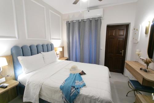 a bedroom with a large bed with a hat on it at Paradise Hotel in Parga