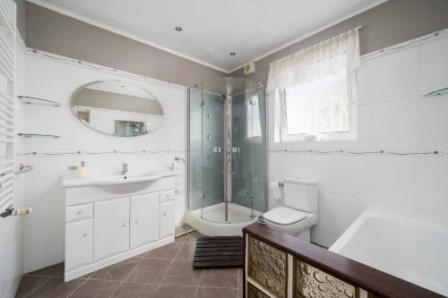 a bathroom with a shower and a sink and a toilet at Family Holiday Villa with Pool in Albufeira