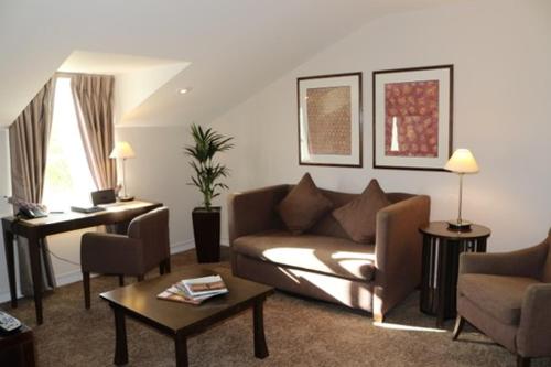 a living room with a couch and a table at Bedford Lodge Hotel & Spa in Newmarket