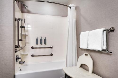 a bathroom with a white tub and a toilet at Courtyard by Marriott Johnson City in Johnson City