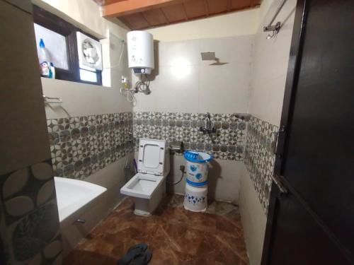 a bathroom with a toilet and a sink at Vineet's homestay in Mukteshwar