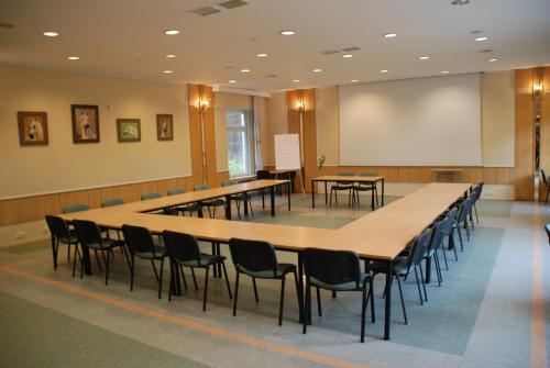 a large conference room with tables and chairs at Hotel Pod Sosnami in Osieck