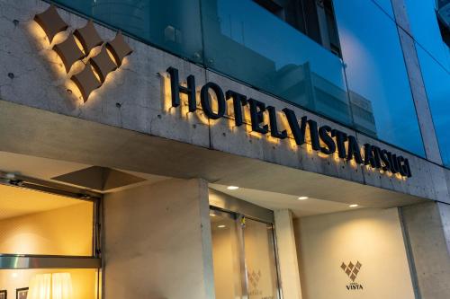 a sign on the side of a building at Hotel Vista Atsugi in Atsugi