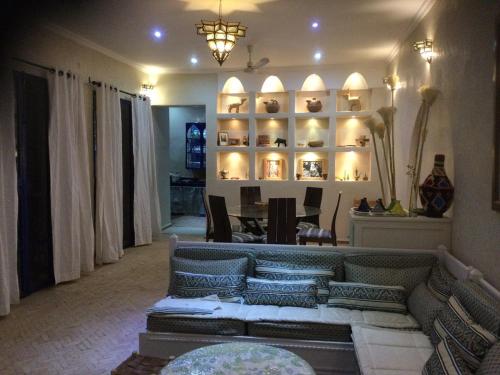 a living room with a couch and a table at Maison Darrayat in Taroudant