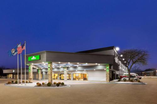 una gasolinera móvil de noche con bandera en Wingate by Wyndham Troy, en Troy