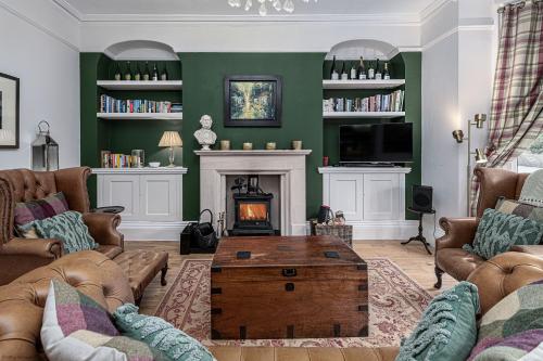 a living room with a couch and a fireplace at No22, Llandudno - Stylish & Cosy Period Apartment, with Hot Tub & Private Parking in Llandudno