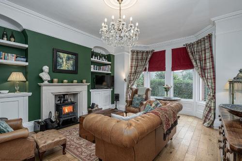 a living room with a couch and a fireplace at No 22 with Hot Tub & Parking in Llandudno